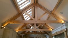 a kitchen with an exposed ceiling and wooden beams