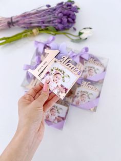 a person holding up a card with an arrow on it and flowers in the background