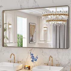 a bathroom with two sinks and a large mirror over it's counter top,