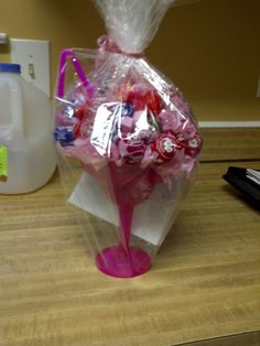 a plastic bag filled with candy sitting on top of a table