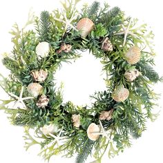 a wreath with sea shells and greenery