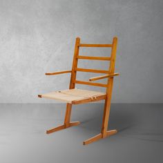 a wooden chair sitting on top of a gray floor