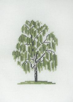 a cross stitch picture of a green tree