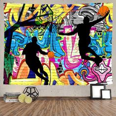 two basketball players are jumping in front of a colorful wall mural with graffiti on it