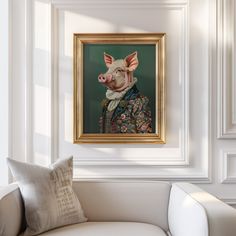 a painting of a pig is hanging on the wall next to a white couch in a living room