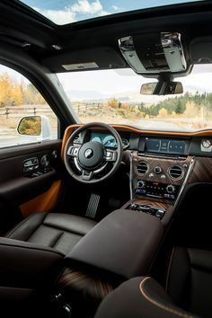 the interior of a car with brown leather and black trims is shown in front of an open window