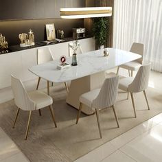 a dining room table with white chairs around it