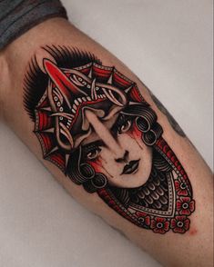 a woman's face with red and black lines on her arm, done by an artist