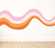 an orange and pink wave wall decal on a white wall