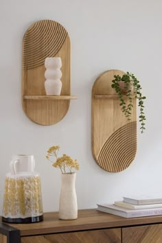 two wooden wall shelves with vases on them