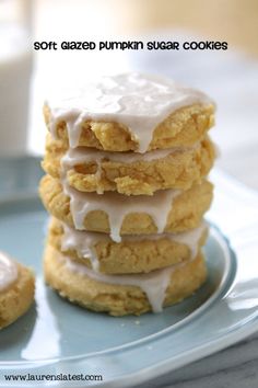 a stack of cookies covered in frosting on top of a blue plate