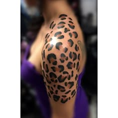 a woman with a tattoo on her arm has a cheetah print on it