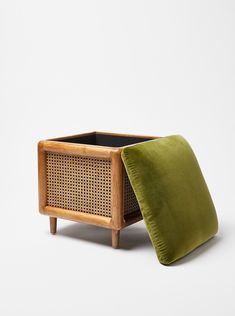 a green pillow sitting on top of a wooden planter