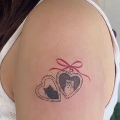 a woman's arm with two hearts and a cat in the heart on it