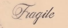 the word fragile is written in cursive writing