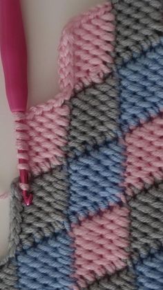 a crocheted blanket with a pink toothbrush in it