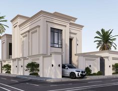 a white car is parked in front of a building with palm trees on the side