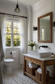 a bathroom with a sink, toilet and window