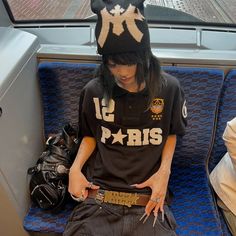 a person sitting on a bus wearing a hat