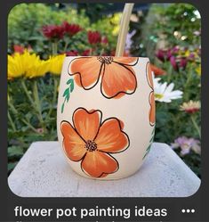 a flower pot painted with orange flowers on it and the words, flower pot painting ideas