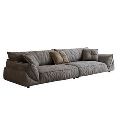 a large gray couch with pillows on it