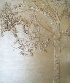 a tree is carved into the side of a wooden board with leaves and branches on it