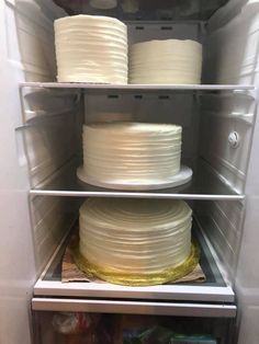 two cakes are stacked on top of each other in the refrigerator