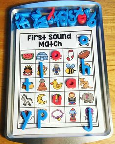 the first sound match is displayed in front of a tray with letters and numbers on it