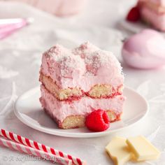 a piece of cake on a plate with raspberries