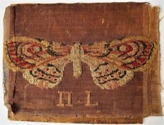 an embroidered butterfly with the letter h on it's back and two smaller wings