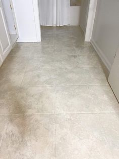 a bathroom with a white toilet sitting next to a sink and a shower curtain in it