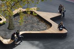 people are sitting on benches in the park