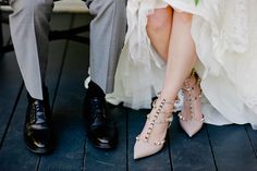 the bride and groom are wearing high heeled shoes with spikes on their ankles,