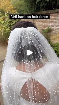 a woman wearing a veil with white dots on it and the words veil back on hair down