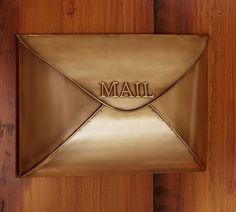 a mailbox with the word mail on it is mounted to a wooden door,