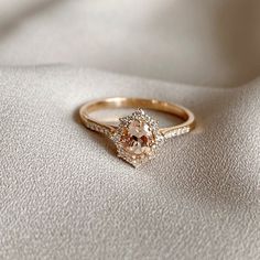 an engagement ring is shown on a white cloth