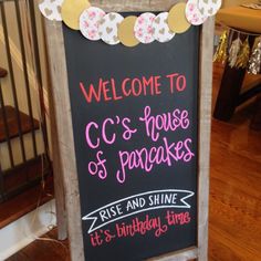 a chalkboard sign with the words welcome to c's house and pancakes