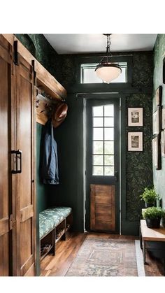 an entryway with green walls and wooden doors, potted plants on the bench