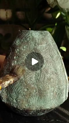 someone is painting a rock with a brush