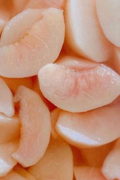 sliced onions are shown in close up on a plate with the skin peeled and uncooked