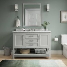 a bathroom with green walls and white fixtures