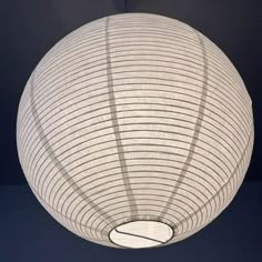 a large white paper lantern hanging from the ceiling