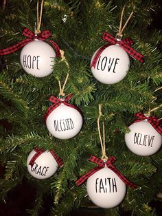 four ornaments hanging from a christmas tree with the words hope, love, and faith