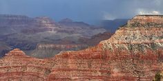 an image of the grand canyon with storm coming in