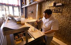 a man preparing food inside of a kitchen