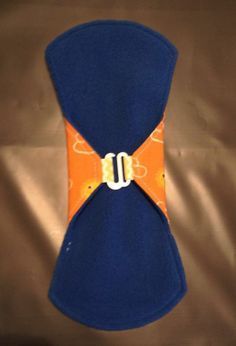 an orange and blue neck tie with a white buckle