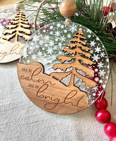 two christmas ornaments with the words all is calm, all is bright