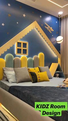 a kid's room is decorated in blue, yellow and gray colors with stars on the ceiling