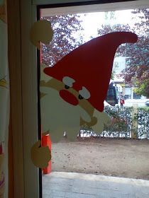 an image of a window decorated with santa claus's hat and reindeer nose on it