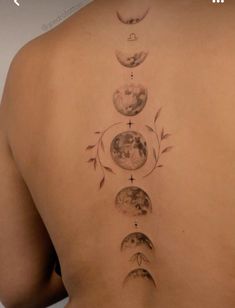 a woman's back with phases of the moon on it